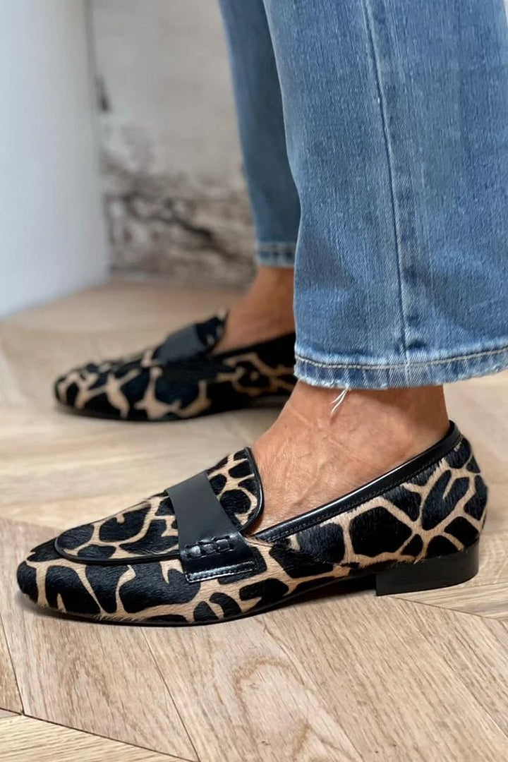 Cow print loafers styled with casual outfit showing versatile everyday wear