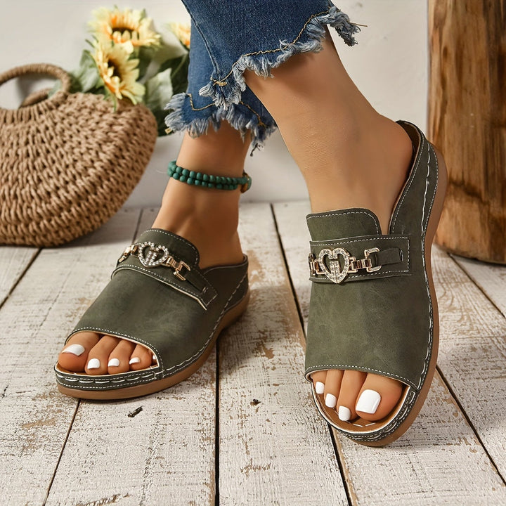 Pair of Alexandra flat sandals in khaki shown from the back