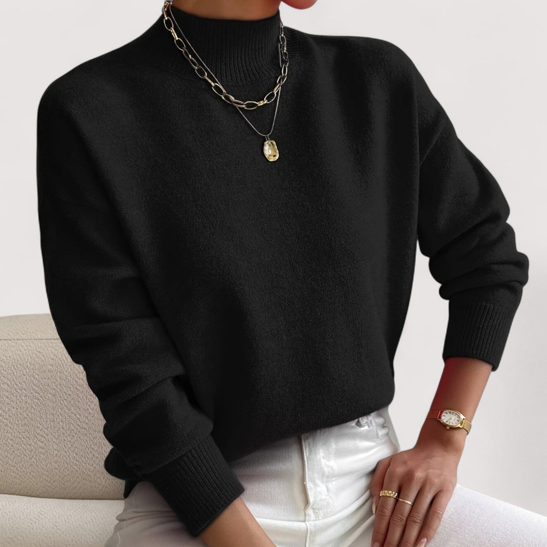Woman wearing a black turtleneck sweater paired with tailored trousers