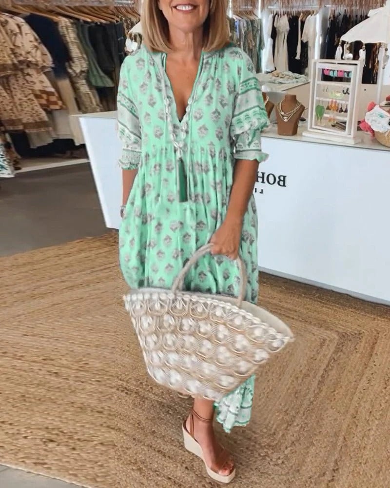 Front view of boho midi tassel dress showing flattering drape and tassel accents in green