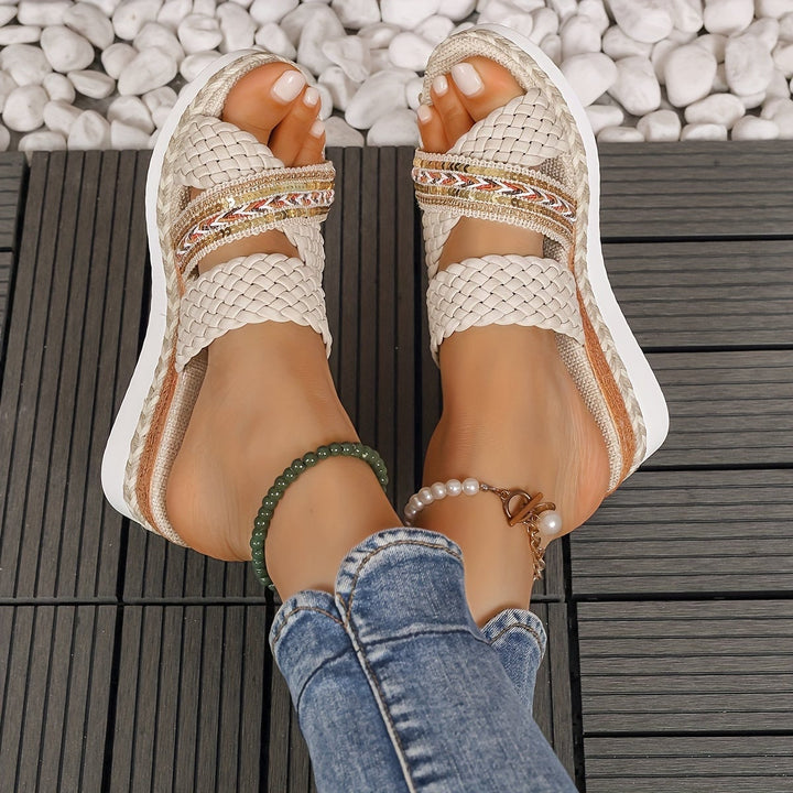 Beatrice ivory white sandals worn on feet against a sun-lit outdoor background