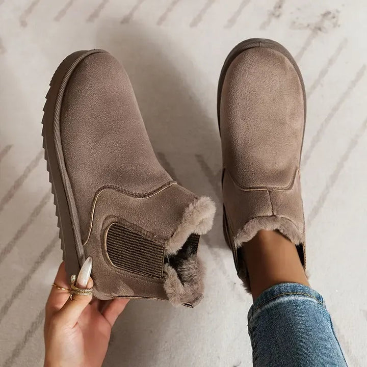 Side profile view of the solid color short boots showing supportive sole and sleek design