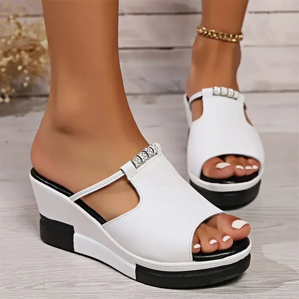 Belle wedge sandal in white worn on foot, front angle showing fit and lift