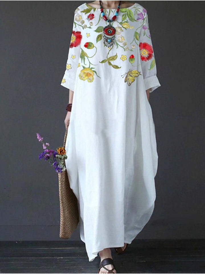 Back view of the white floral draped maxi dress showing the elegant flowing design