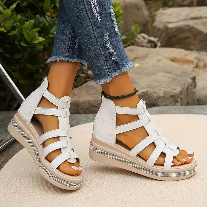 Flat lay of all three Blythe wedge sandal color options: black, beige, and white