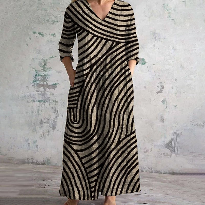 Woman wearing a brown and black vintage striped V-neck dress with a flowing silhouette, styled for a casual daytime look
