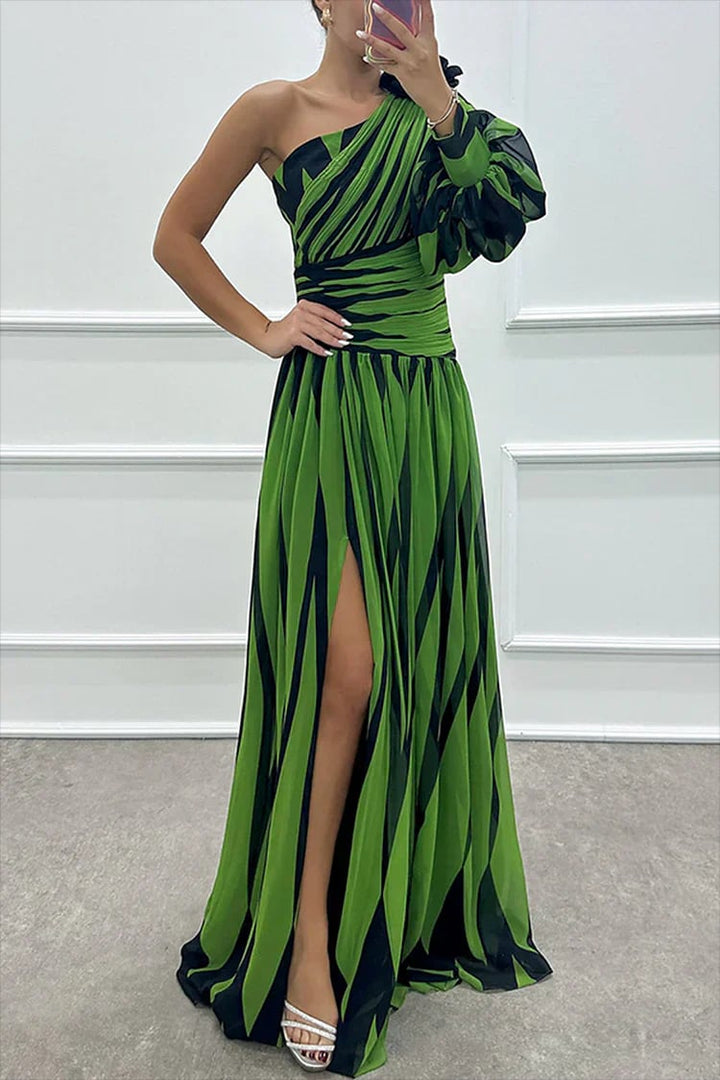 Back view of a navy blue striped one-shoulder maxi dress with a flowing skirt