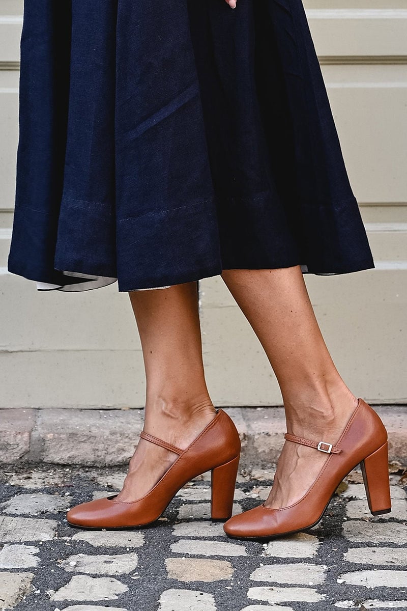 Top-down view of brown low-heel sandals showing the full footbed and strap layout