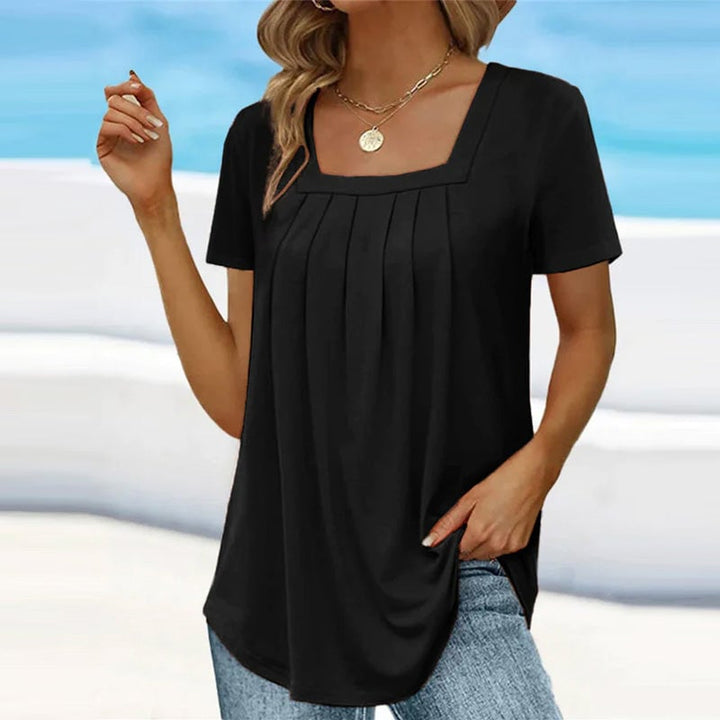 Model styled in the BobaFashion pleated blouse paired with trousers for a polished, put-together look