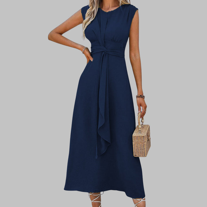 Model wearing a sleeveless round neck maxi dress in dark blue for an evening look