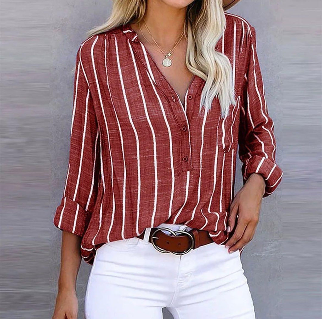 Red striped blouse styled with high-waist trousers for a polished casual look