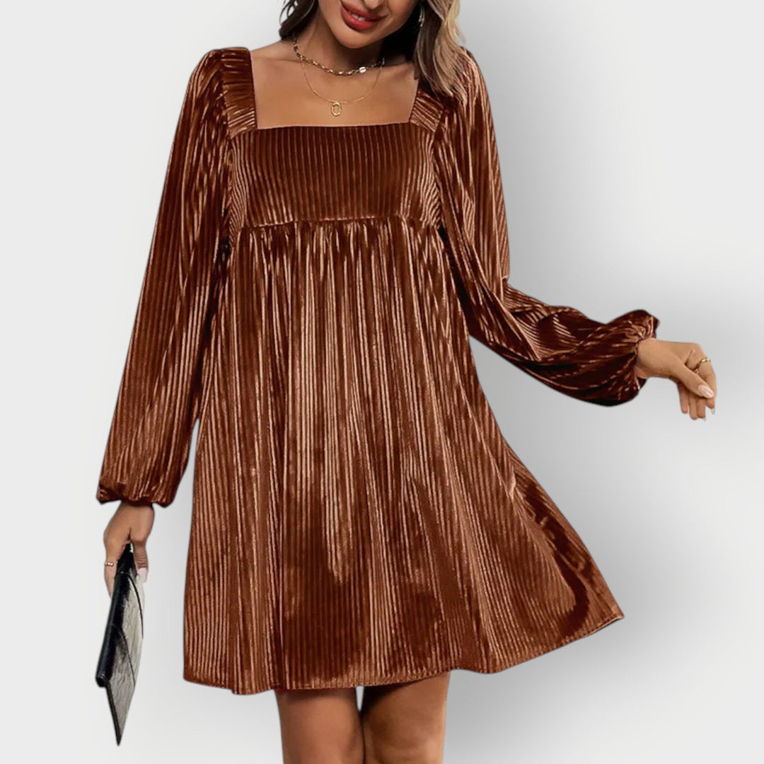 Back view of a brown velvet backless dress showing the open-back design and tailored fit