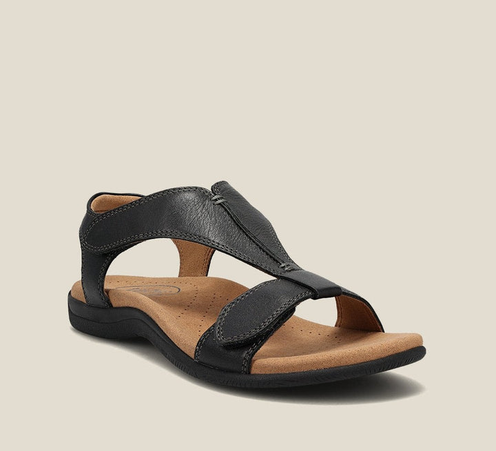 Woman wearing Carolyn orthopedic sandals in blue while walking on a sunny city street