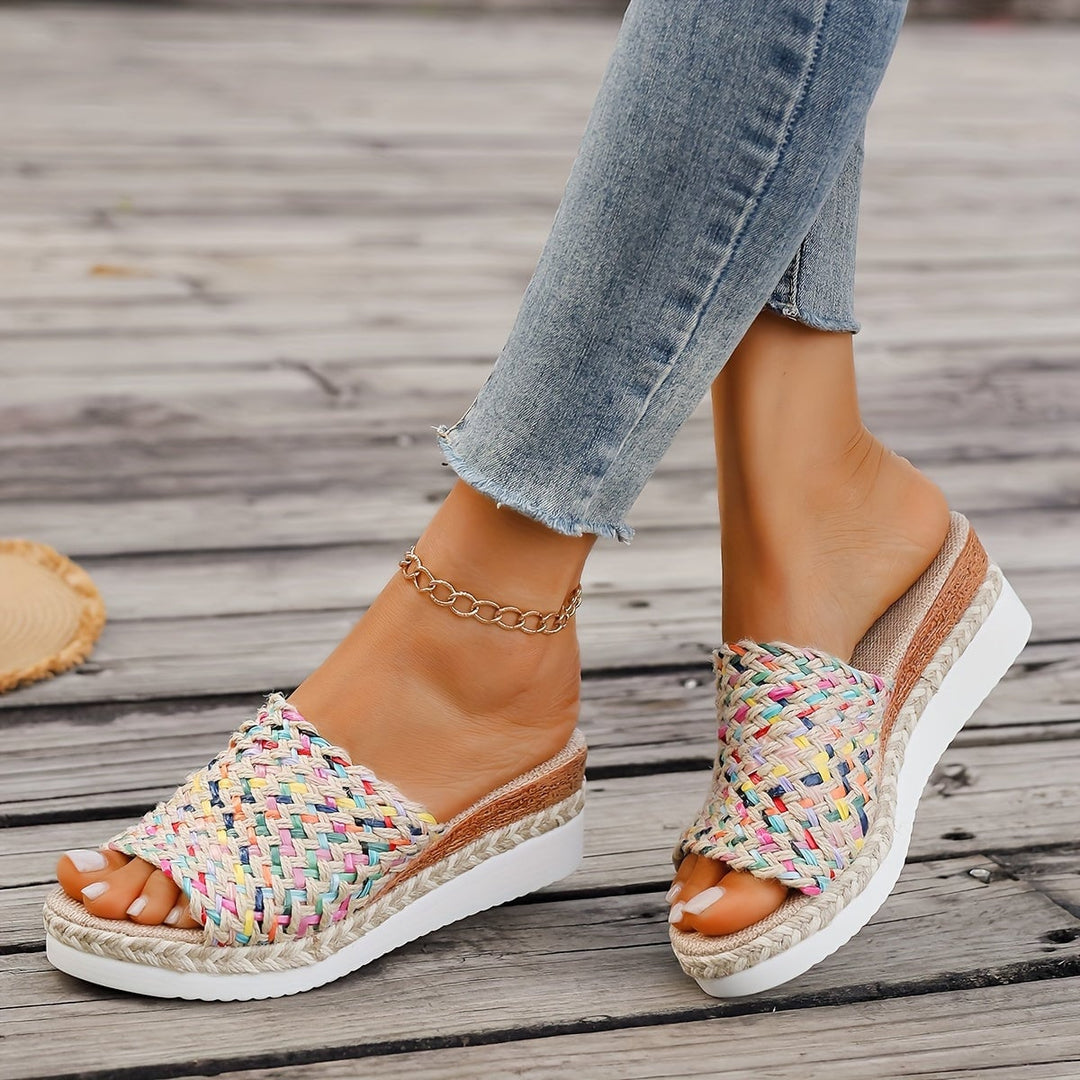 Close-up of artisanal woven strap detailing on Celeste wedge sandals
