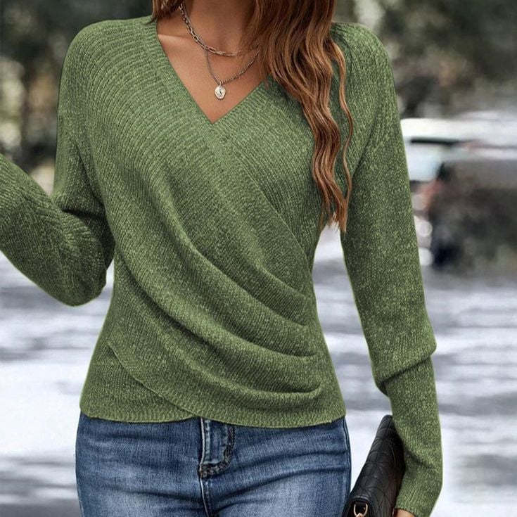 Close-up of the Celeste wrap front sweater in navy blue showing the soft knit fabric and draped hem detail