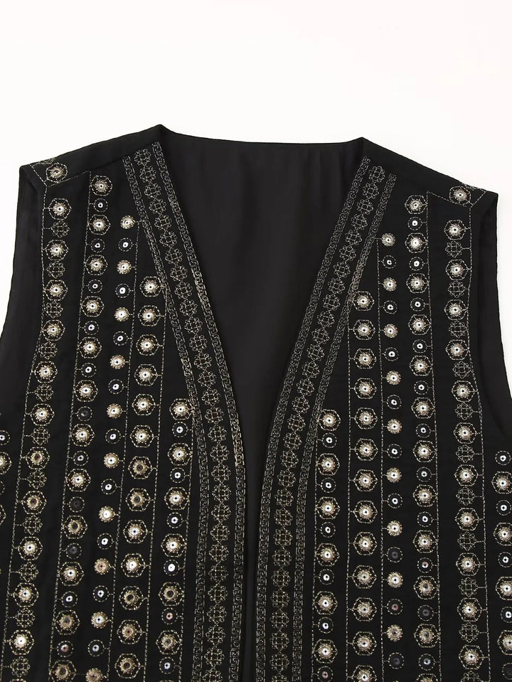 Model wearing black sequin boho vest layered over a camisole top