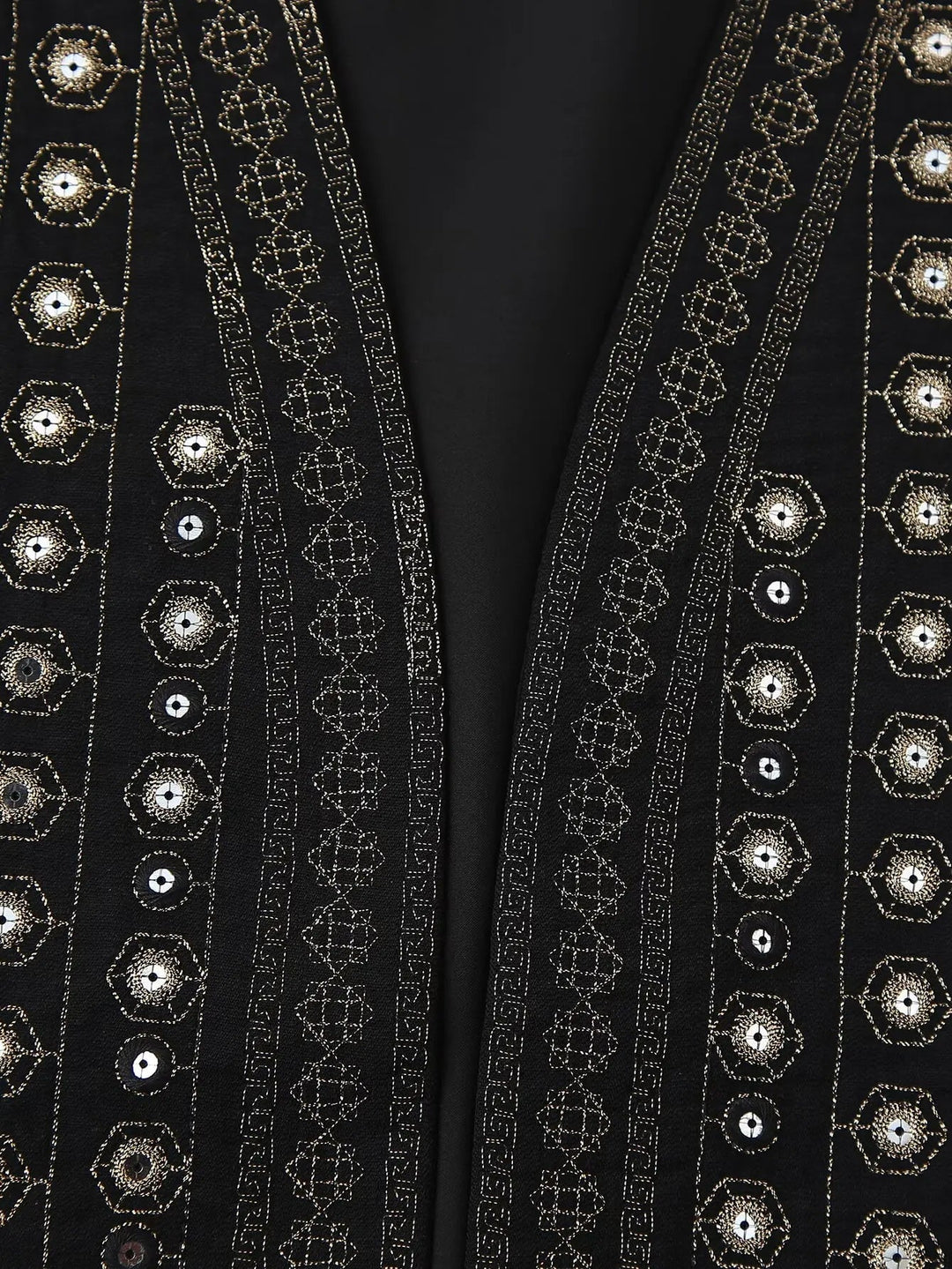 Model in black sequin boho vest styled with high-waisted jeans