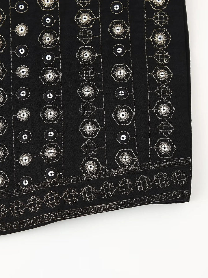 Detail shot of sequin and embroidery texture on black boho vest
