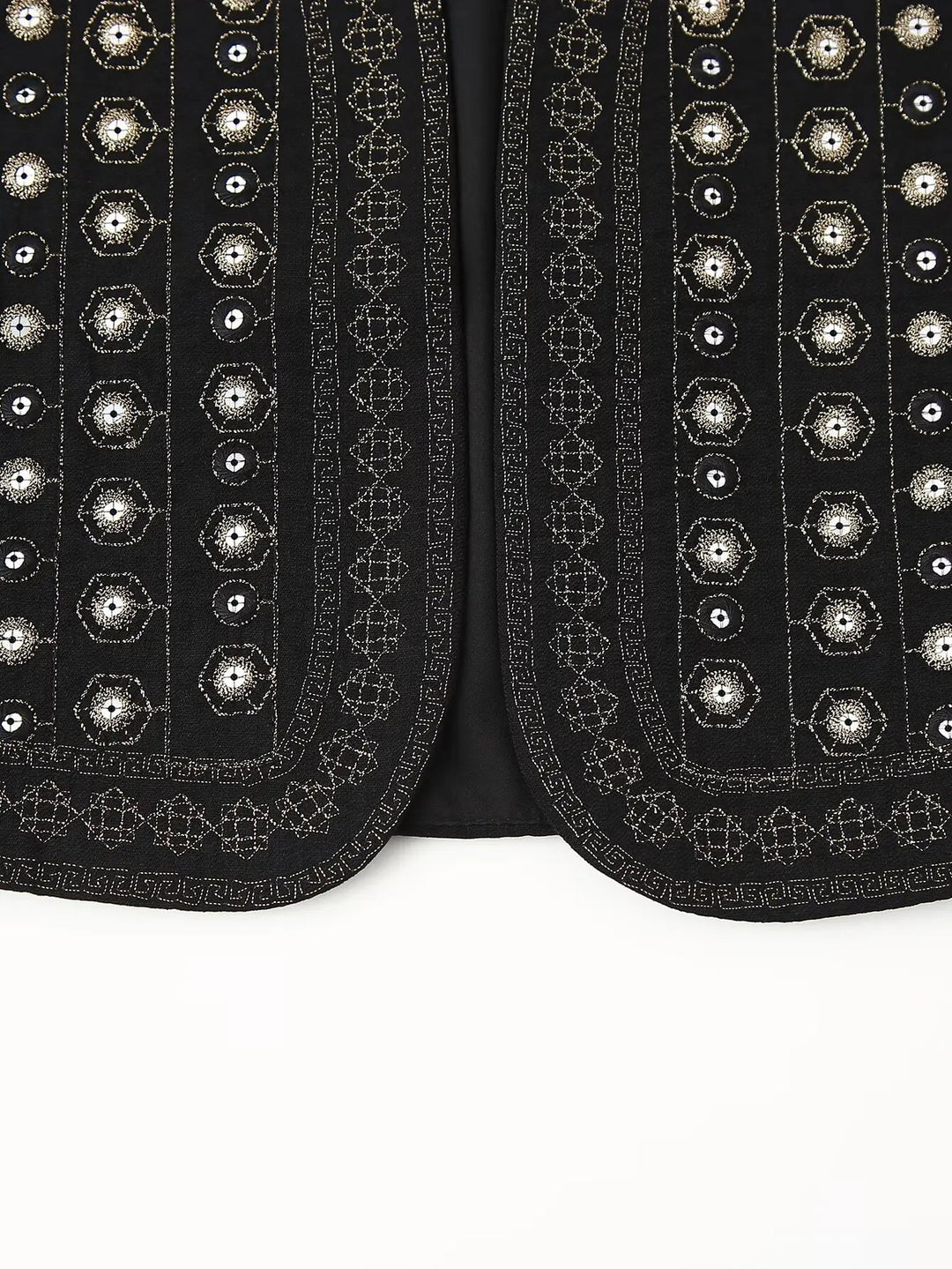 Model wearing black sequin vest at festival-style outdoor setting