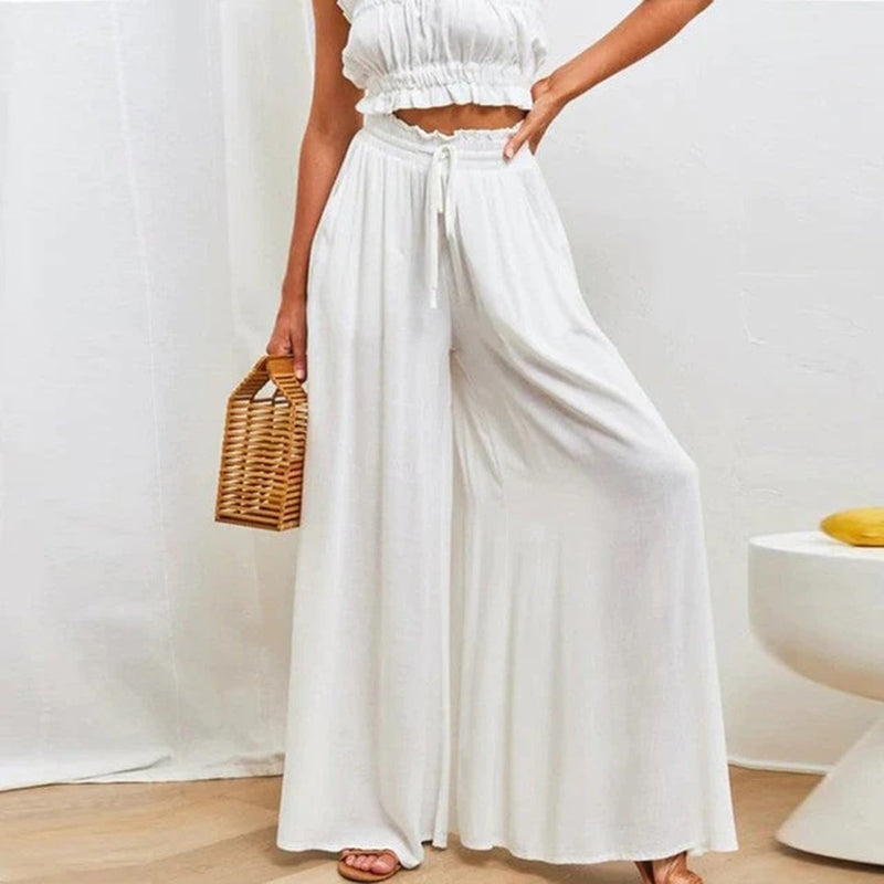 Front view of women's high waisted wide leg palazzo pants in navy with flowing silhouette