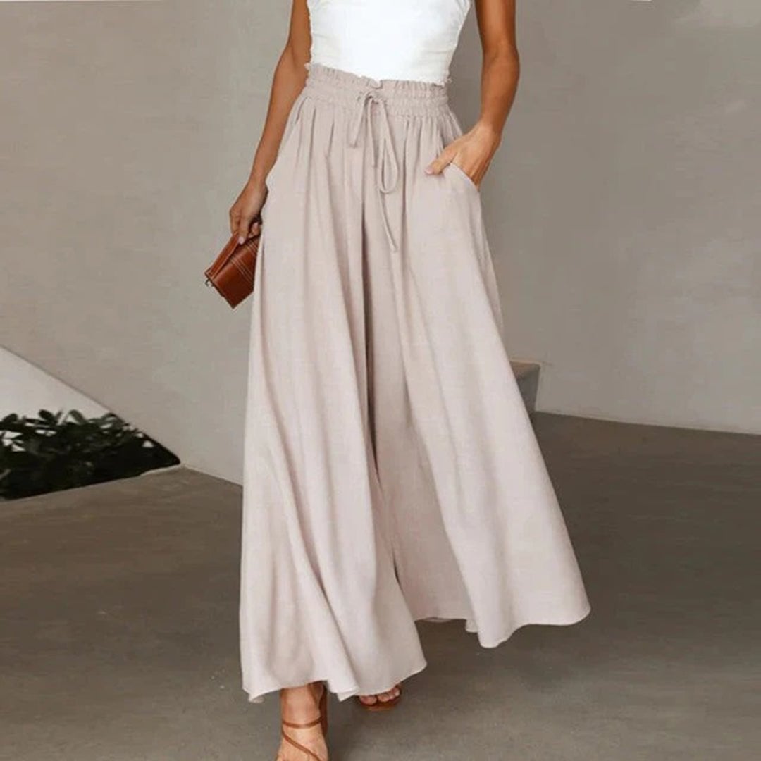 Full-length view of wide leg palazzo pants in blue on a standing model