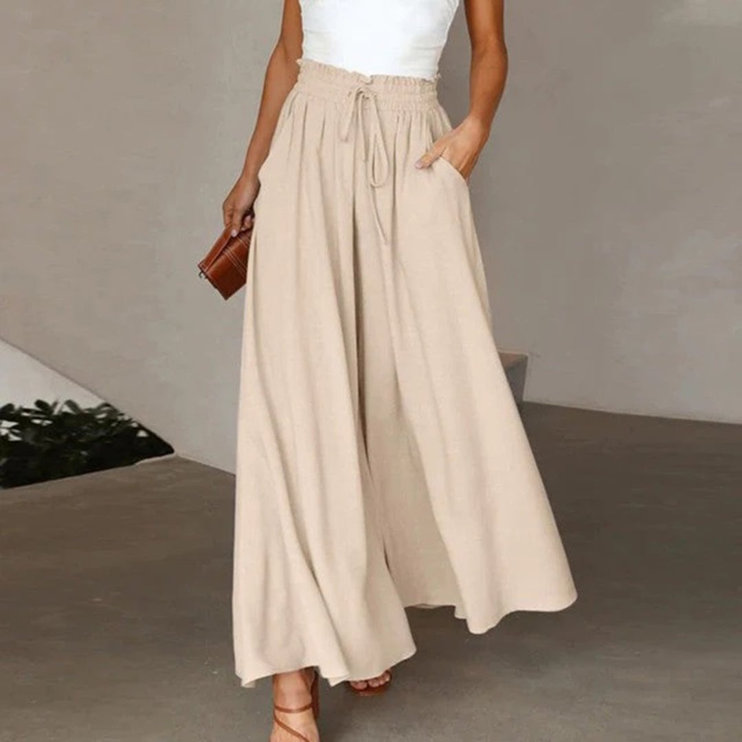 Women's palazzo pants in beige styled casually with sandals