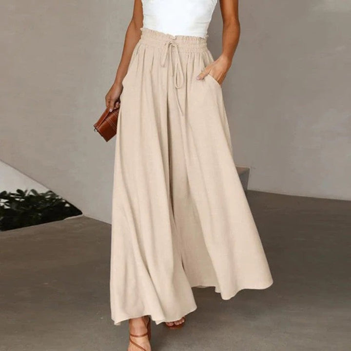 Women's palazzo pants in beige styled casually with sandals