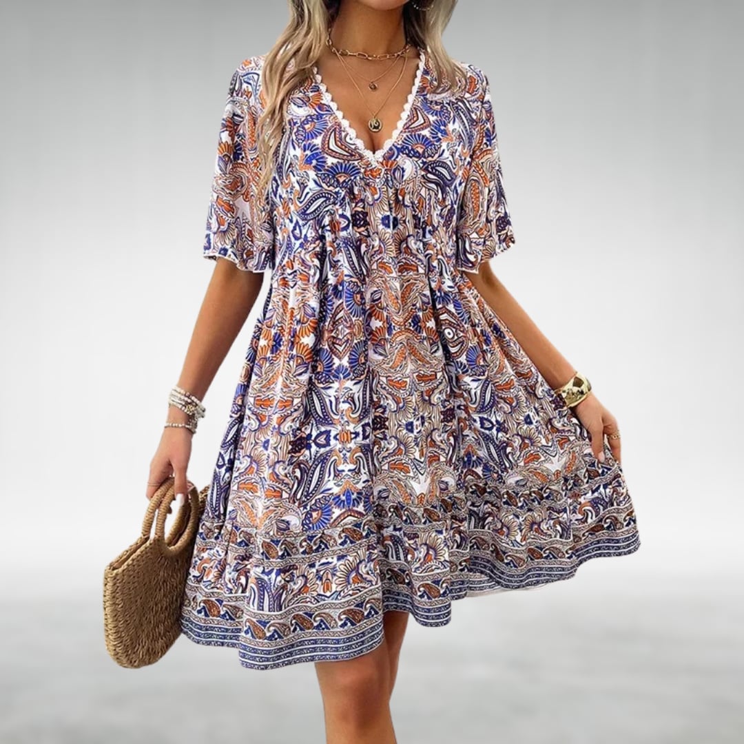 Woman wearing the Dahlia draped cocktail dress in a flattering silhouette, showcasing its elegant drape and sophisticated detailing