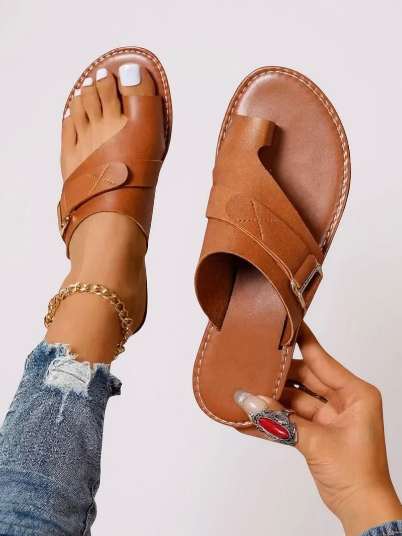 Diana toe-loop slides in brown with cushioned sole and clean minimalist silhouette on a neutral background