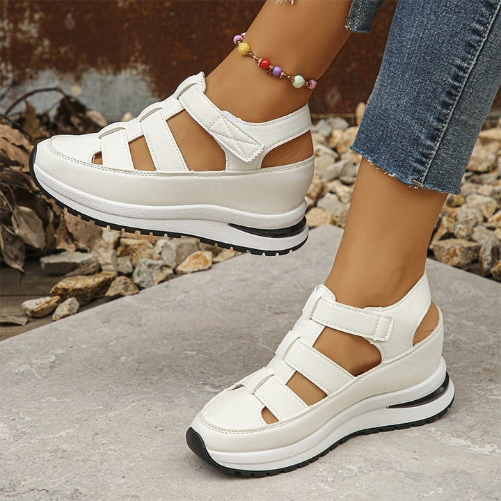 Heel detail of Diane elevated sole sneakers in black showing sole height