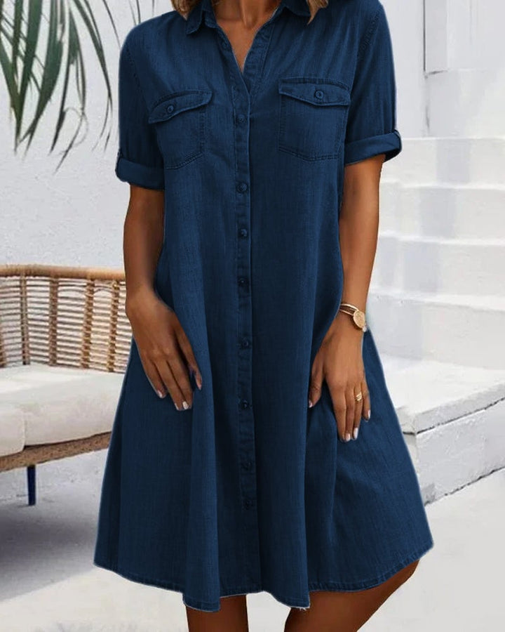 Model in black denim-look dress styled with casual accessories