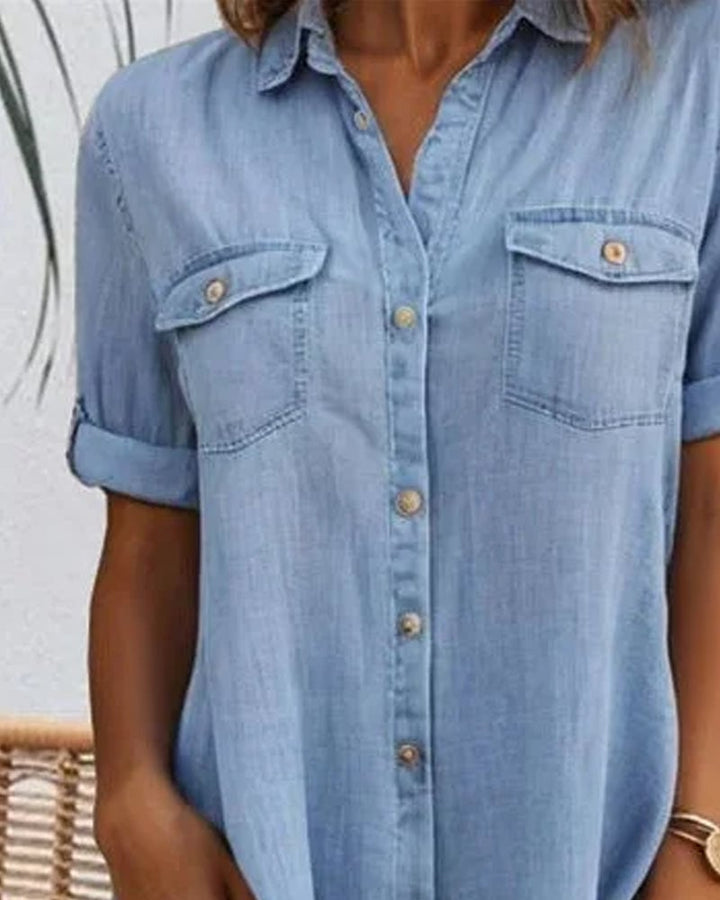 Close-up of the button-down front and rolled sleeve detail on the denim-look dress
