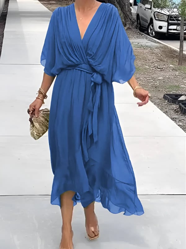Side view of the Eden draped midi dress in blue highlighting graceful fabric movement