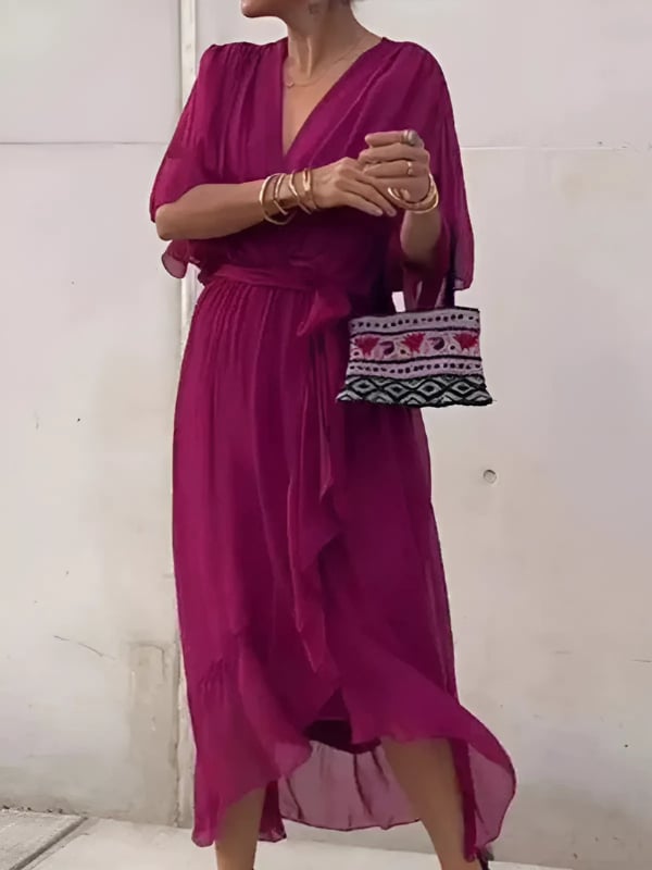 Woman posing in the Eden wrap dress in violet showcasing the flattering wrap waist detail