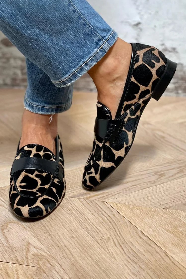 Top-down view of black animal print loafers highlighting the eye-catching pattern and polished finish
