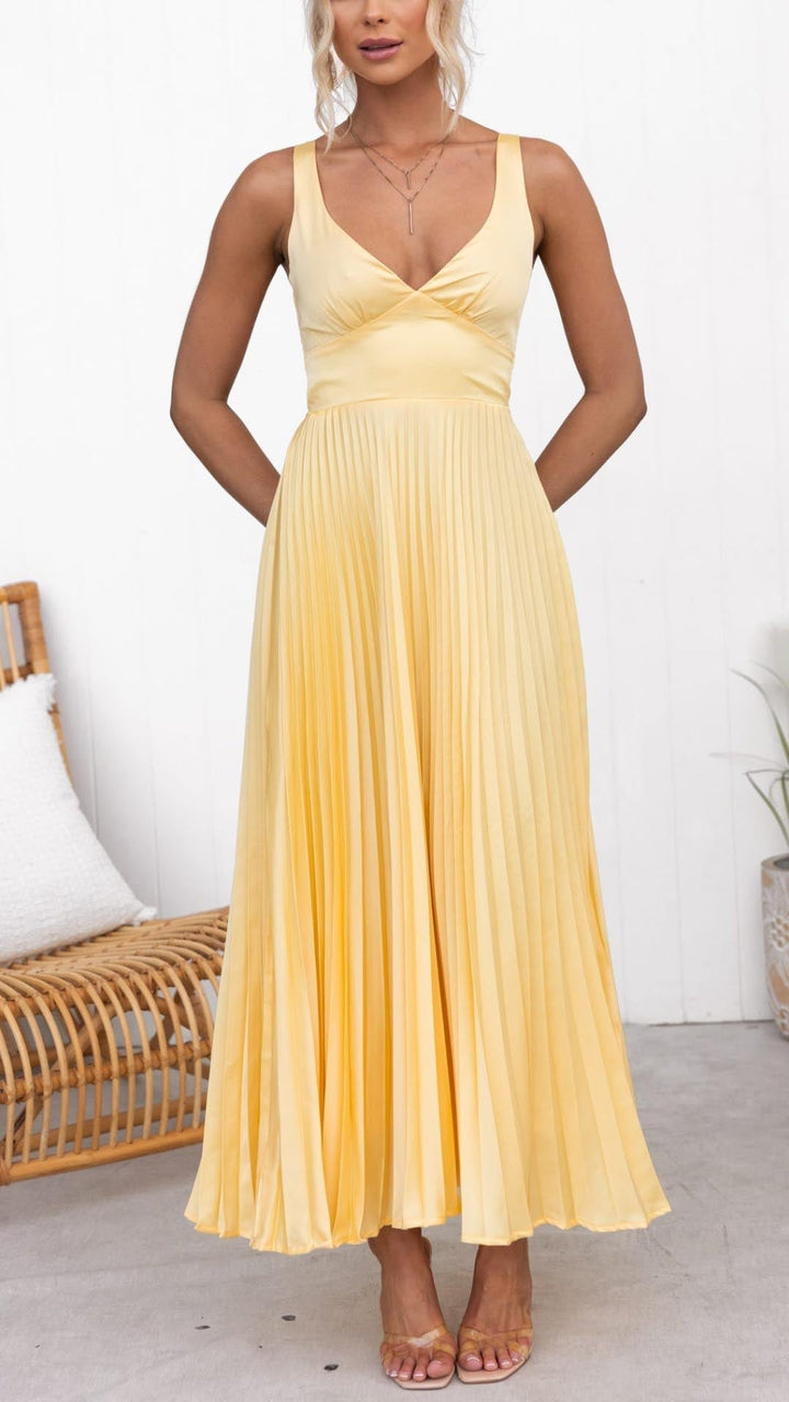 Front view of yellow pleated maxi dress showing flowy skirt and V-neckline