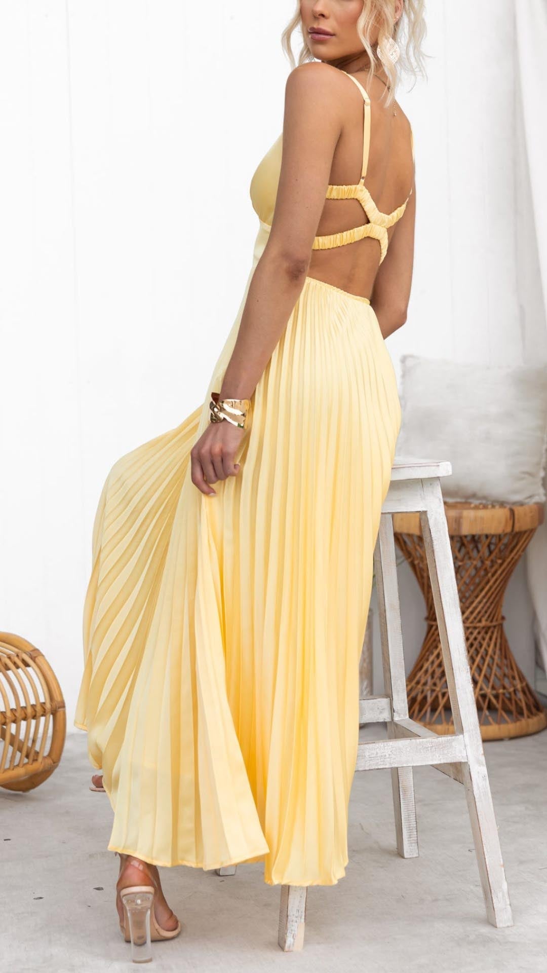 Back view of yellow maxi dress highlighting adjustable crisscross straps