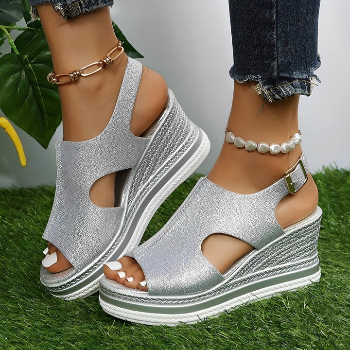 Flat lay of all six Emerson sandal color options: Silver, Gold, Pink, Black, Blue, and Beige