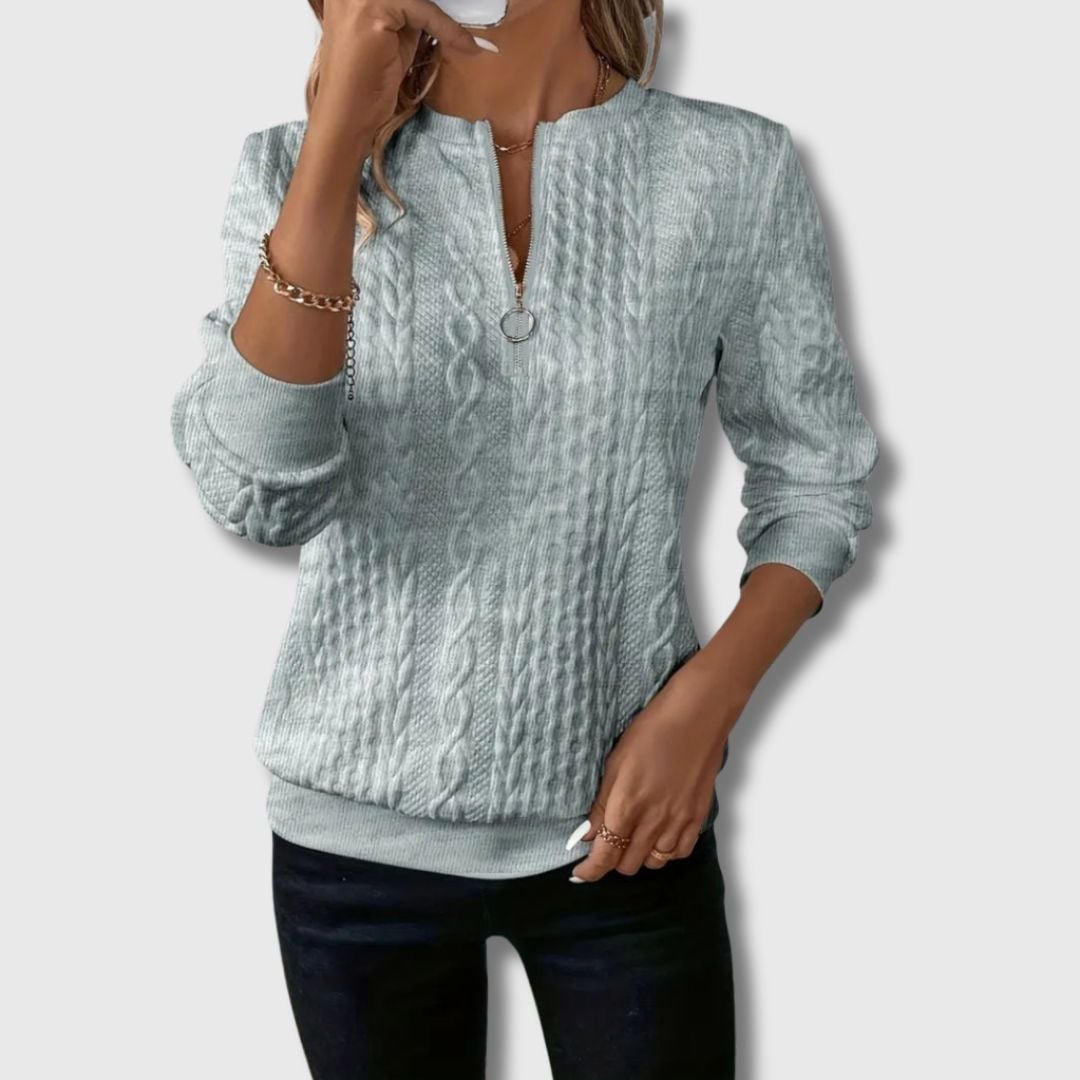 Close-up detail of the Emily elegant sweater showing soft premium fabric texture and clean finish