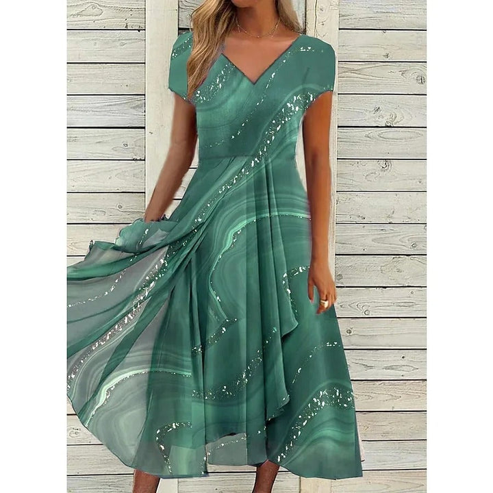 Full-length view of a woman in a green V-neck midi dress showing the flattering flowing hem
