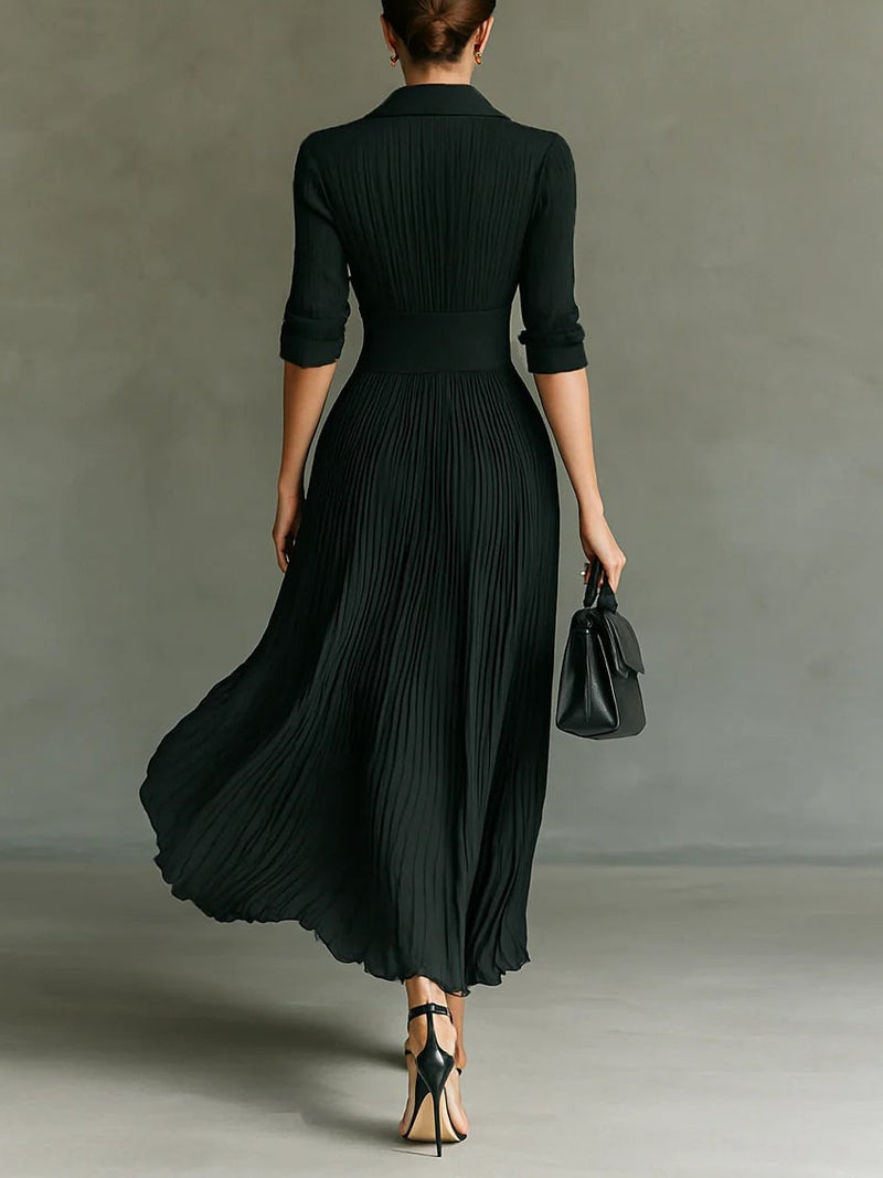Close-up of the fitted waist detail on a black midi dress showing smooth fabric and tailored shaping