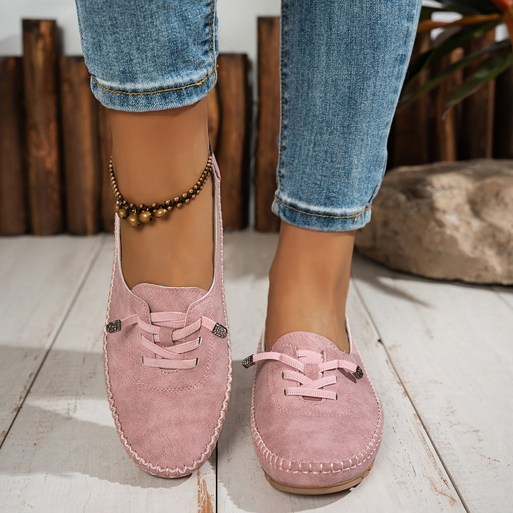 Evelyne loafers in black paired with tailored trousers, lifestyle shot