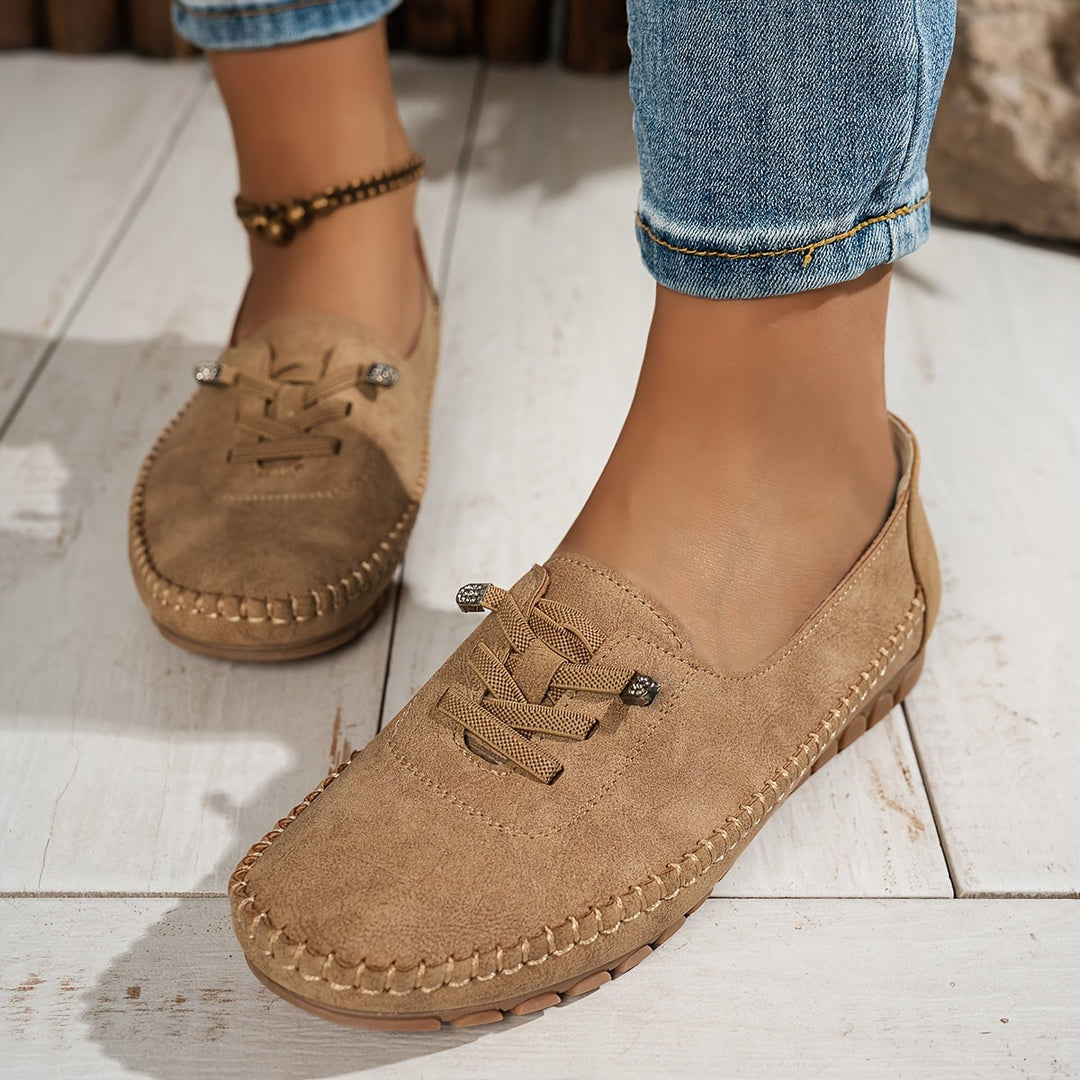 Evelyne loafers in blue on a flat lay with casual wardrobe pieces