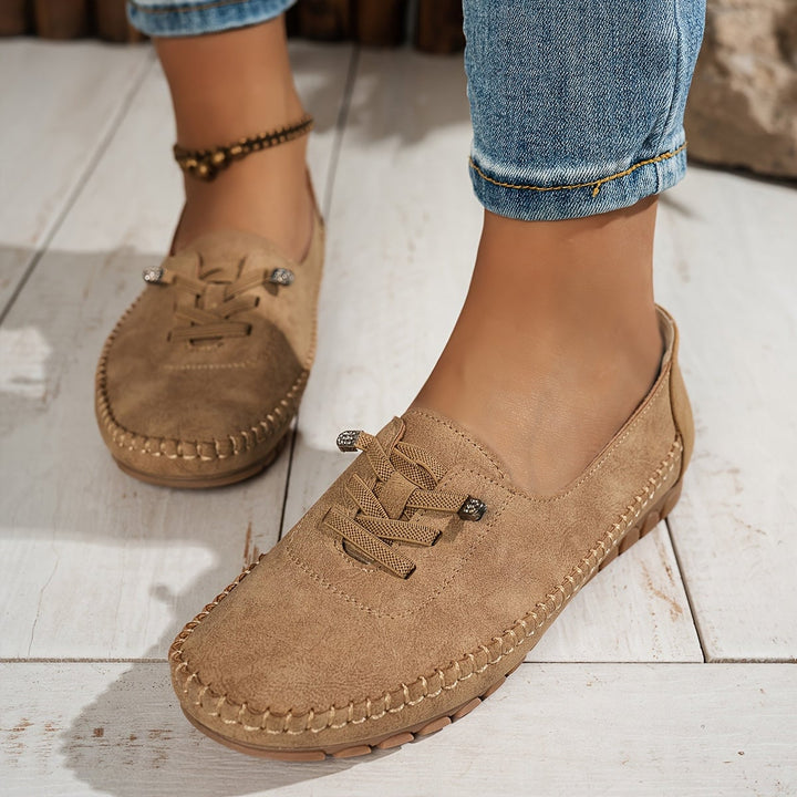 Evelyne loafers in blue on a flat lay with casual wardrobe pieces