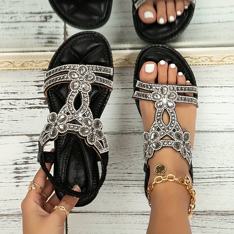 Close-up of gold Faye sandal showing ornate strap and sole detail