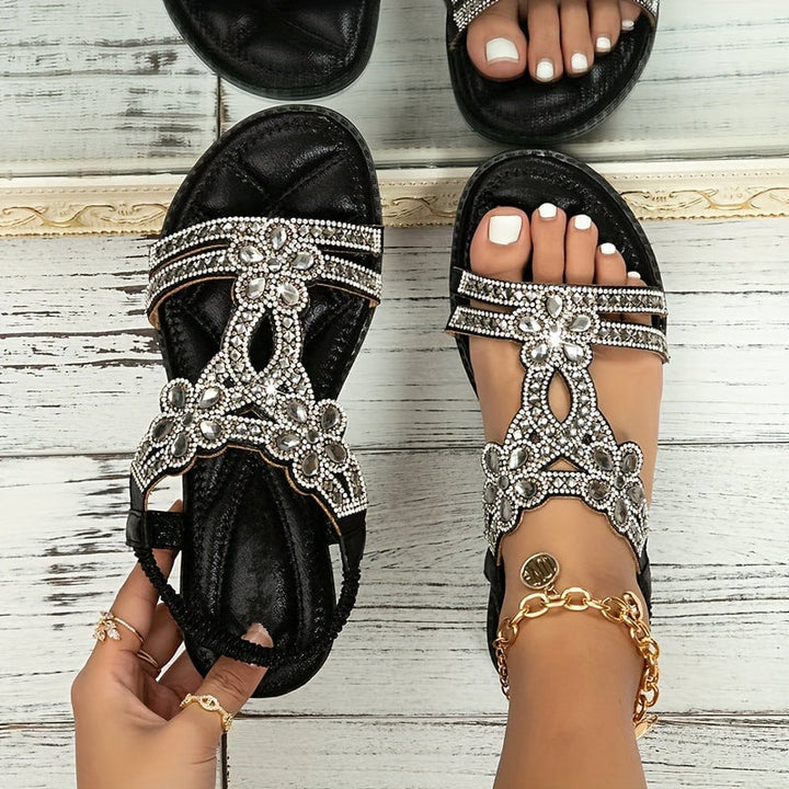 Close-up of gold Faye sandal showing ornate strap and sole detail