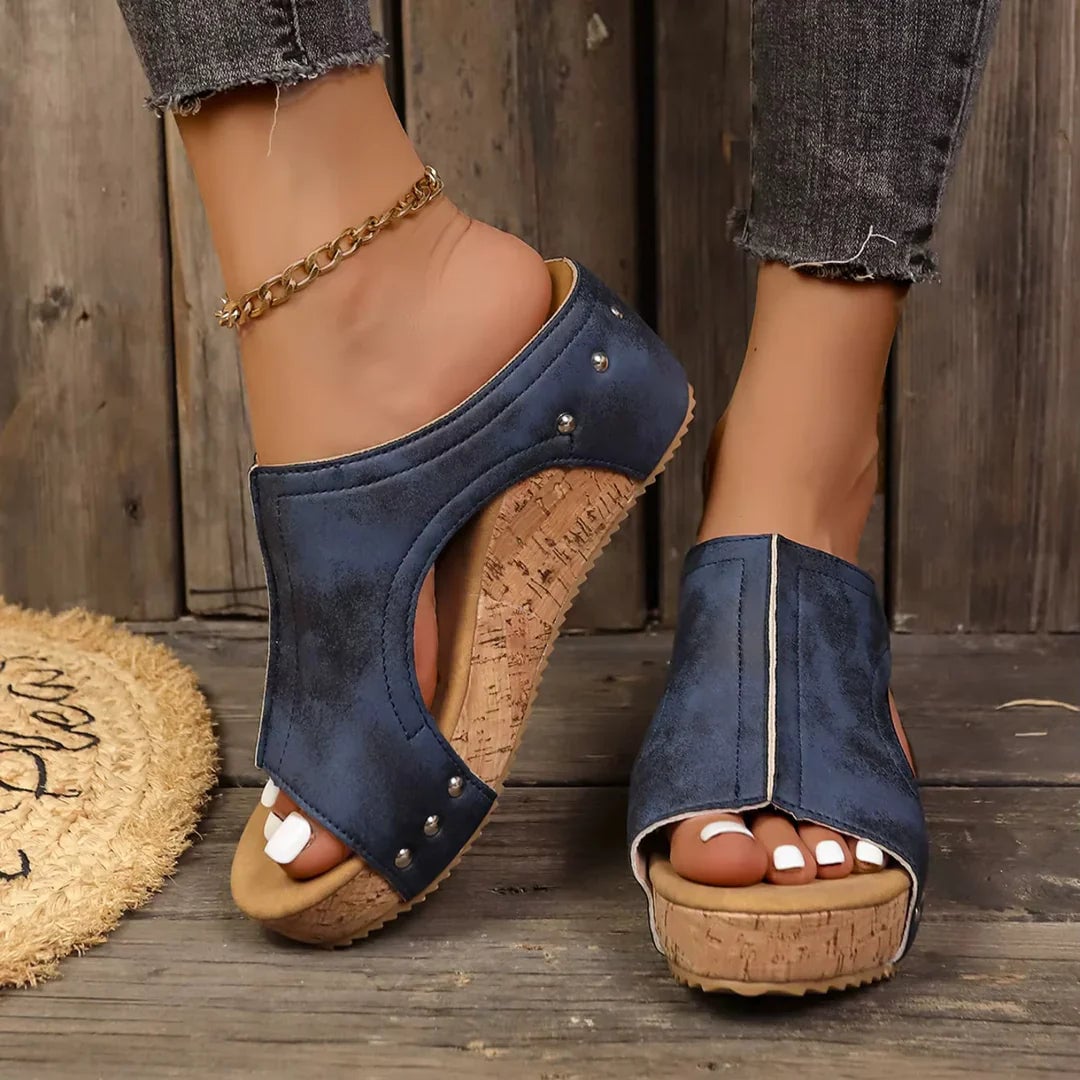 Close-up of metallic stud detailing on the straps of the Felicity wedge sandals