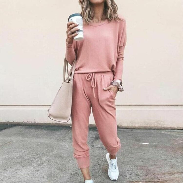 Model wearing a coordinated two-piece set in a solid color, featuring a flattering top and matching bottoms