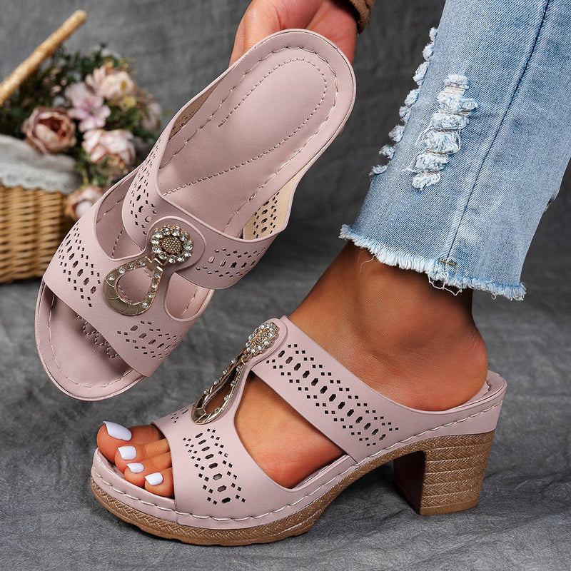 Close-up of rhinestone accents on Finley flat sandals in black