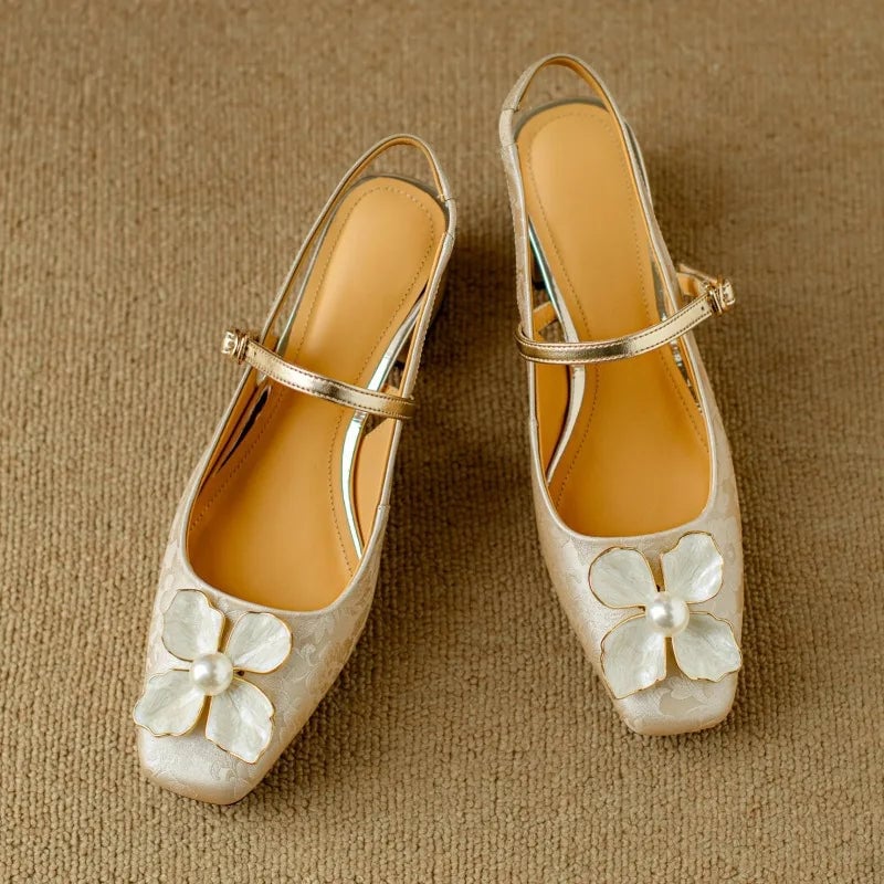 Model wearing Florine floral slingback pumps in beige styled with tailored trousers